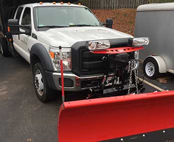 white truck with red snowplow blade