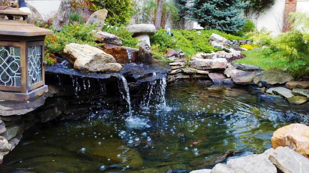 landscaped koi pond with a waterfall