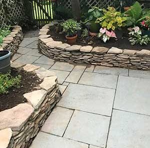stone walkway with low natural stone wall on each side