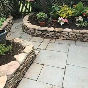stone walkway with low natural stone wall on each side